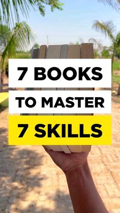 a person holding up a book with the title 7 books to master seven skills on it