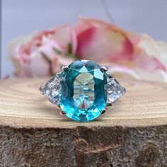 "Paraiba Tourmaline Engagement Ring White Gold Oval Cut Neon Blue Paraiba Tourmaline Ring For Women Unique Wedding Anniversary Ring This ring is an oval lab created blue paraiba with trillion side stones made with solid 14k white gold item #6022 youtube: https://www.youtube.com/watch?v=Cvg-OkB0uoA White sapphire are more translucent than other stones and need to be cleaned more often -Approximate total carat weight: 3.80ctw diamond equivalent -Center Stone Size: 10x8mm - approx. 3.00ct diamond e Oval Sapphire Ring With Diamonds, Paraiba Tourmaline Engagement Ring, Ring For Women Unique, Paraiba Tourmaline Ring, Oval Sapphire Ring, Tourmaline Engagement Ring, Wedding Anniversary Ring, White Sapphire Engagement Ring, Paraiba Tourmaline