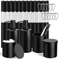 black and white bathroom accessories including soap dispenser, toothbrush holder, shower curtain