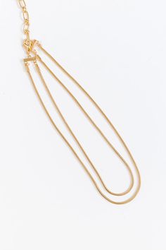 - Layer on the charm with this simply chic necklace! - Gold colored brass material - Two connected chain strands for a layered look - Adjustable length chain and clasp closure - Size: 14.5-17.5 inches Double Strand Metal Necklace With Delicate Chain, Gold Double Snake Chain Necklace, Gold Adjustable Double Chain Necklace, Gold Double Chain Adjustable Necklace, Adjustable Gold-tone Double Chain Necklace, Gold Double Strand Necklace With Lobster Clasp, Adjustable Double Chain Gold-tone Necklace, Gold Double Chain Snake Necklace In Minimalist Style, Minimalist Gold-tone Chain Necklace With Lobster Clasp