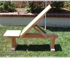 a wooden bench sitting in the grass