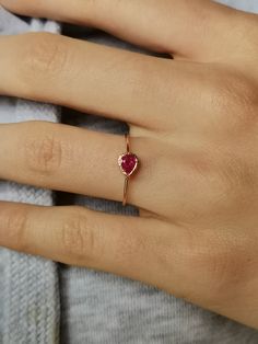 Natural Ruby Ring handcrafted in 14k gold, tear drop ring, 14k gold ring. This is a beautiful ruby ring with tiny heart cut out in the back - 100% handcrafted which can become a wonderful treasure to cherish for years to come. Ruby is July birthstone. CENTRAL STONE: * natural, Earth mined gemstone- ruby * teardrop placed horizontally APPROXIMATE MEASUREMENTS OF THE RING: *band: approximately 1 mm *material: 14k gold (yellow/rose/white) *size- please pick from the drop down menu. If you need othe Rose Gold Ruby Ring As Gift, Rose Gold Ruby Ring Gift, 14k Gold Ruby Ring For Valentine's Day Gift, Dainty Ruby Birthstone Ring For Formal Occasions, Dainty Ruby Ring For Formal Occasions, Rose Gold Ruby Diamond Ring Gift, Dainty Ruby Ring As Birthstone, Ruby Teardrop Ring, Dainty Ruby Ring For Promise