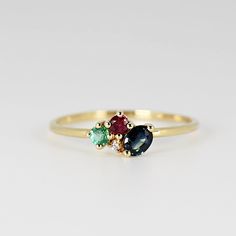 This beautiful cluster ring was made of 14k gold band, 14k gold prong settings. It's perfect as engagement ring or statement piece. DETAILS ABOUT THE RING, MATERIAL AND STONES * 14k 1.2 mm solid gold band and prongs. * 5x3 mm oval shape sapphire * 2.5 mm round emerald and ruby * 1.5mm diamond, 0.015ct * Birthstones : September, May, July and April We can make this design with any of gemstones. Please contact us. This ring was hand crafted in Melt'm Jewelry Studio in California. Thanks for visiti Sapphire Cluster Ring, Multi Gemstone Ring, Ring Sapphire, Solid Gold Band, Jewelry Studio, Gold Band, Cluster Ring, Gemstone Ring, Gold Bands