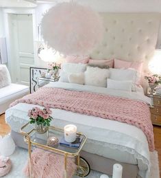 a bedroom with pink and white decor on the walls, flooring and bedding