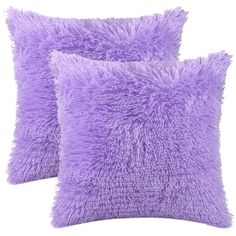 two purple fluffy pillows sitting on top of each other