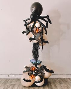 a balloon sculpture made to look like a spider with wings and bats on it's back