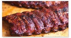 a piece of meat sitting on top of a wooden cutting board