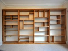 empty bookshelves in an empty room with no one on the floor or furniture