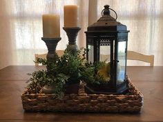 a candle and some plants on a table