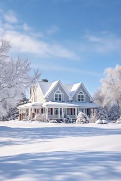 a large white house surrounded by snow covered trees