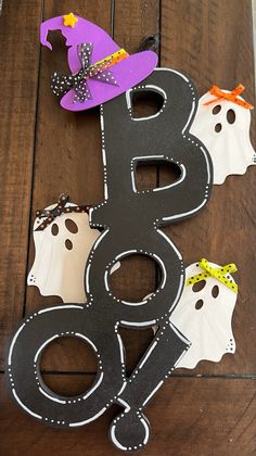 a wooden table topped with halloween decorations and paper cut outs on top of each other