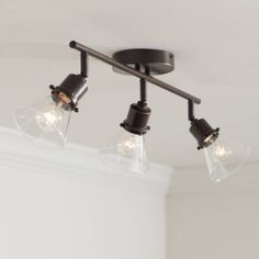 three lights are hanging from the ceiling in a room