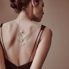 a woman with a flower tattoo on her back