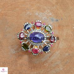 Tanzanite Gemstone Ring, Ruby Gemstone Ring, Sapphire Gemstone Ring, Pave Diamond Jewelry, 925 Silver Jewelry, Gold Vermeil Jewelry, Gifts Gross Weight: 16.34 gram Diamond Weight: 1.20 cts Gemstone Weight: 16.85 cts Ring Size: 38X34 MM NOTE:- All The Products Are Designed And Manufactured In My Workshop By Me & My Team. Shown Products Are Purely Handmade. Custom Orders Are Open Handly Accepted. We Are the Perfect Choice For Any Custom Jewelry Manufacturing. For Bulk Orders Please Message me. Multicolor Amethyst Ring Fine Jewelry, Multicolor Multi-stone Amethyst Ring, Multicolor Center Stone Ring, Multicolor Gemstone Cluster Ring, Multicolor Gemstone Rings, Multicolor Ruby Ring With Gemstone, Multicolor Round Ruby Ring, Multicolor Hallmarked Jewelry Ring, Multicolor Round Jewelry With Center Stone