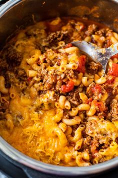 a pot filled with pasta and ground beef