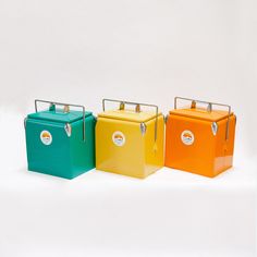 four different colored lunch boxes sitting side by side