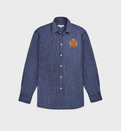 Made from 100% cotton. Our denim shirts are made in Portugal at one of the finest and oldest European shirt maker. Oversized fit with a classic collar, curved hem and buttoned cuffs. - 100% Cotton denim- Oversized fit- Mother of pearl buttons - Made in Portugal Fit Mother, Oversized Denim Shirt, Denim Shirts, Shirt Maker, Sporty And Rich, Short Shirts, Mother Of Pearl Buttons, Pearl Buttons, Quilted Jacket