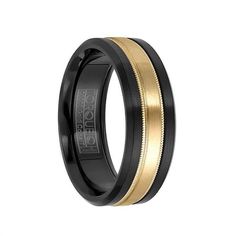 black and gold wedding band with two tone inlaying the center, on an isolated white background