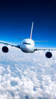 an airplane is flying above the clouds