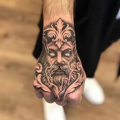 a man's hand with a tattoo on it