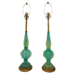 a pair of green glass and brass table lamps