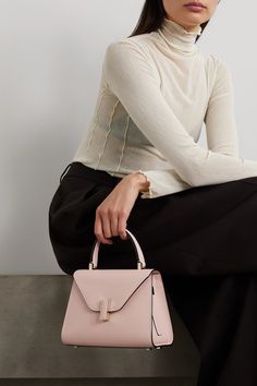 Valextra's 'Iside' mini tote is an icon in its own right, with its distinctive structure and compact size. Crafted in Italy from blush textured-leather, this one has an internal pocket to safely store your most-used belongings and studs at the base to prevent scratches. Attach the strap and wear it cross-body on busier days. Elegant Pink Textured Leather Shoulder Bag, Luxury Pink Bags For Workwear, Luxury Pink Bags For Work, Chic Pink Shoulder Bag For Workwear, Pink Top Handle Bag For Work, Elegant Blush Bag With Top Carry Handle, Chic Pink Bags For Work, Elegant Pink Shoulder Bag For Work, Modern Pink Textured Leather Bag