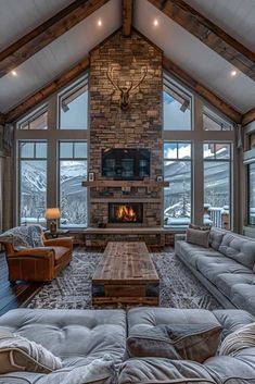 a living room filled with furniture and a fire place in the middle of a room