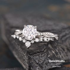 a white gold engagement ring with diamonds on top