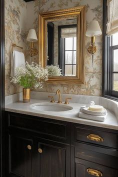 a bathroom vanity with two sinks and a large mirror above it, in front of a window