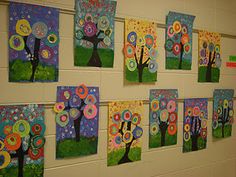 art work displayed on the wall of a school hallway with trees and flowers painted on them