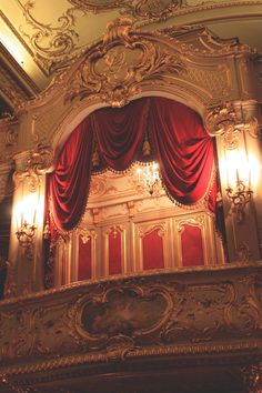 an ornately decorated stage with red curtains