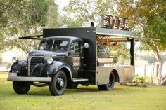 an old truck is parked in the grass