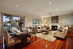 a living room filled with furniture and a fire place in the middle of a room