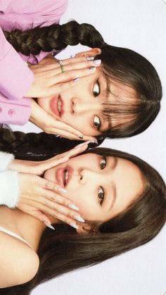 two young women with long hair are posing for the camera