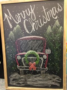 a chalk board with a car and wreath on it