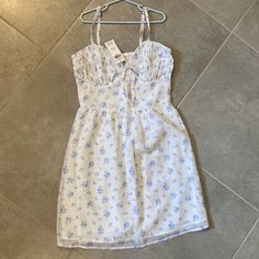 Gorgeous Smocked White And Blue Floral Hollister Dress. Womens Size Xs. Nwt Never Worn. Nwt. Sold Out! Light Blue Smocked Bodice Mini Dress, Casual Spring Sundress With Ruched Detail, Casual Mini Sundress With Smocked Bodice, Casual Sundress With Smocked Bodice Mini Length, Casual Light Blue Smocked Dress, Blue Casual Dresses With Smocked Bodice, Blue Casual Dress With Smocked Bodice, Casual Blue Dresses With Smocked Bodice, Blue Mini Sundress With Smocked Bodice