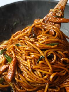 some noodles are being cooked in a wok