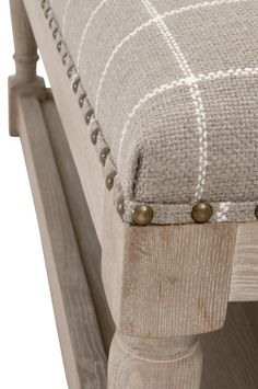 a close up of a wooden bench with buttons on the seat and backrests