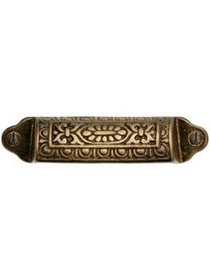 an antique brass door handle with intricate designs