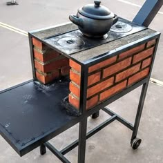 an outdoor oven made out of bricks with a black pot on it's top