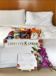 a bed with flowers and some snacks on it