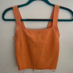 Peachy-Orange Coloured Tank. Ribbed Knit. Stretches To Form Body. Square Neckline. Square Low-Back. Chest: 28" Waist: 22" Length: 18" 51% Viscose. 49% Polyamide. Machine Wash. Size Small New With Tags Orange Ribbed Sleeveless Top, Trendy Orange Seamless Top, Casual Orange Seamless Tops, Orange Fitted Knit Top For Spring, Fitted Orange Knit Top For Spring, Fitted Orange Knitted Tops, Fitted Knitted Orange Top, Summer Orange Knitted Tops, Orange Knitted Summer Tops