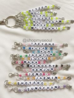 several key chains with words written in different colors and shapes, all on a white background