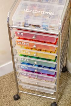 a stack of plastic drawers sitting on top of a carpeted floor