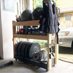 a rack with plates and dumbs in front of a car