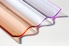 an image of a close up view of a glass tube with red and purple streaks on it