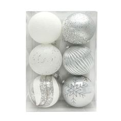 white and silver ornaments in a clear box