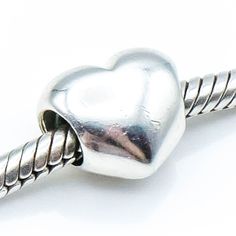 "Authentic PANDORA Sterling Silver Heart Charm, 925 ALE, Retired. Say \"I love you\" with this simple but elegant heart. It matches any bracelet design and reminds her of you. This item is retired from production and may be difficult to find. Charm is pre-owned and in great condition. This beautiful bead will add a special touch to your bracelet creation. The charm shown in the pictures is the one you will receive. Feel free to message me with any questions. Fast shipping and handling from Birmi Classic Gold Heart Charm Bracelet, Valentine's Day Heart Bracelet With Sterling Silver Clasp, Classic Gold Bracelet With Heart Charm, Everyday Silver Heart Charm Bracelet, Silver Heart Bracelet For Everyday Wear, Everyday White Gold Heart Bracelet, Pandora Heart, Murano Glass Beads, Pandora Silver