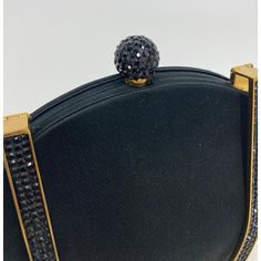 Judith Leiber black Silk Crystal Fold over Handle Clutch in excellent condition. black silk trimmed with gold hardware and black swarovski crystals. Unique fold over top handle design easily converts between clutch and handbag styles. Vintage piece from the 60s with original Arnold's department store tag still intact. overall excellent condition. no stains smells or scuffs. very light wear on edges around interior top- not visible when worn- see photos. measurements: 8"x7"x2" 4" handle drop Handbag Styles, Judith Leiber, Handle Design, The 60s, Fold Over, Black Silk, Department Store, Fashion Handbags, Gold Hardware