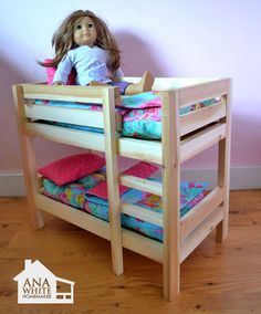 a doll sitting on top of a bunk bed